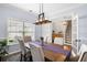 Stylish dining room with hardwood floors, a dining table, natural light, and easy access to other rooms at 8402 Loggers Run, North Charleston, SC 29420