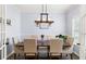 Elegant dining room featuring a wooden table, upholstered chairs, and stylish lighting fixtures, perfect for gatherings at 8402 Loggers Run, North Charleston, SC 29420
