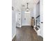 Welcoming foyer with hardwood floors, neutral paint, decorative lighting, and an entry to the living space at 8402 Loggers Run, North Charleston, SC 29420