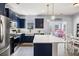 Spacious kitchen featuring navy blue cabinets, stainless steel appliances, and a dining area with natural light at 8402 Loggers Run, North Charleston, SC 29420