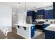 Bright, modern kitchen with stainless steel appliances, navy cabinets, and an island perfect for cooking and entertaining at 8402 Loggers Run, North Charleston, SC 29420