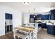 Contemporary kitchen design with navy blue cabinetry, stainless steel appliances, and a convenient wine cooler at 8402 Loggers Run, North Charleston, SC 29420