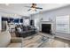 Open concept living room with a fireplace, ceiling fan, and hardwood floors at 8402 Loggers Run, North Charleston, SC 29420