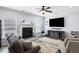 Inviting living room featuring a fireplace, mounted TV, and modern decor at 8402 Loggers Run, North Charleston, SC 29420