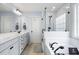 Bright and open main bathroom with double sinks, a soaking tub, and a walk-in shower at 8402 Loggers Run, North Charleston, SC 29420