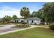 Charming community pool area with palm trees, cabana, and inviting atmosphere for relaxation at 8402 Loggers Run, North Charleston, SC 29420