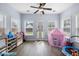 Sunroom with multiple windows, a door to the backyard, and ample space for to play at 8402 Loggers Run, North Charleston, SC 29420