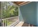 Comfortable balcony space with nature views, white railing, and wooden floor at 9019 Parlor Dr, Ladson, SC 29456