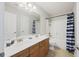 Bathroom featuring double sinks, wood cabinets, and a bathtub with shower at 9019 Parlor Dr, Ladson, SC 29456