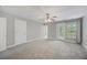 Spacious bedroom with a ceiling fan, large windows and doors to let in lots of sunlight at 9019 Parlor Dr, Ladson, SC 29456
