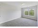 Carpeted bedroom with natural light from the window overlooking the trees at 9019 Parlor Dr, Ladson, SC 29456