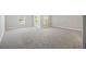 Large, carpeted bedroom with lots of natural light from windows and a door at 9019 Parlor Dr, Ladson, SC 29456