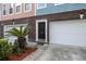 Close-up of townhome exterior with brick base, garage, and a well-manicured front yard at 9019 Parlor Dr, Ladson, SC 29456