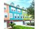 Colorful townhome exterior featuring vibrant paint, brick accents, and well-maintained landscaping at 9019 Parlor Dr, Ladson, SC 29456