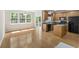 Bright kitchen with wood cabinets, black appliances, and large windows for natural light at 9019 Parlor Dr, Ladson, SC 29456
