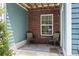 Cozy patio seating area with turquoise siding and exposed beam ceiling at 9019 Parlor Dr, Ladson, SC 29456