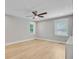 Bright bedroom with hardwood floors, ceiling fan, and windows with bright white trim at 924 Trent St, Charleston, SC 29414