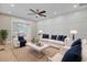 Stylish living room featuring elegant white furniture, chic decor, and a large ceiling fan at 924 Trent St, Charleston, SC 29414