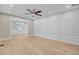 Spacious living room featuring light wood flooring, and white wainscoting with modern recessed lighting at 924 Trent St, Charleston, SC 29414