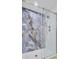 Close-up of a luxurious glass-enclosed shower with blue marble-style tiling at 924 Trent St, Charleston, SC 29414