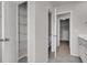 Hallway with access to a bathroom, walk-in closet, and linen closet featuring wire shelving at 9998 Winged Elm St, Ladson, SC 29456