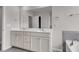 Bathroom featuring double sinks, white cabinetry, framed mirror, and tiled flooring at 9998 Winged Elm St, Ladson, SC 29456
