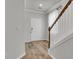 Bright entryway with hardwood floors, a staircase, and white trim at 9998 Winged Elm St, Ladson, SC 29456