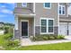 Charming exterior with stone accents, manicured landscaping, and a covered entrance at 9998 Winged Elm St, Ladson, SC 29456