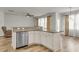 View of a kitchen island with bar seating, stainless steel dishwasher, and granite countertops at 9998 Winged Elm St, Ladson, SC 29456