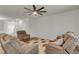 Spacious living room featuring wood floors, neutral paint, ceiling fan, and comfortable upholstered seating at 9998 Winged Elm St, Ladson, SC 29456