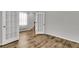 Inviting room with wood-look floors, a large window, and elegant french doors at 9998 Winged Elm St, Ladson, SC 29456