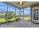 Relaxing screened-in porch with a ceiling fan and string lights, perfect for outdoor enjoyment at 9998 Winged Elm St, Ladson, SC 29456