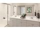 Elegant bathroom featuring a double sink vanity, marble countertops, and a glass-enclosed shower with a bench at 1013 Swamp Rose Run, Summerville, SC 29485