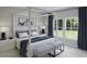 This primary bedroom features a four poster bed, ensuite bathroom, and a large window at 1013 Swamp Rose Run, Summerville, SC 29485