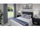 Serene bedroom featuring a plush bed, soft lighting, and a view of lush greenery through the large window at 1013 Swamp Rose Run, Summerville, SC 29485