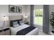 Cozy bedroom with natural light, a comfortable bed with decorative pillows, and stylish nightstands at 1013 Swamp Rose Run, Summerville, SC 29485