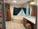 Bathroom features a tub, tile flooring, window, and oak vanity at 104 Dean Dr, Summerville, SC 29483