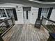 Front porch with black chair and wood railings at 104 Dean Dr, Summerville, SC 29483