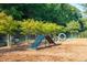 Fun agility course in community dog park features a-frame, jump hoops, and shaded bench for relaxation at 104 Snow St, Summerville, SC 29486