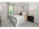 Cozy bedroom with a metal frame bed, carpet, and natural light from a large window at 105 Indigo Cove Blvd, Summerville, SC 29486