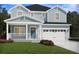 Charming two-story home featuring light blue siding, covered front porch, and a two-car garage at 105 Indigo Cove Blvd, Summerville, SC 29486
