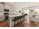 Modern kitchen with gray cabinets, stainless appliances, a center island with seating, and an open dining area at 105 Indigo Cove Blvd, Summerville, SC 29486