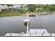 Scenic aerial view of a private pier with boat lift stretching into the serene waters at 108 Fairbanks Oak Aly # 201, Charleston, SC 29492