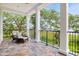 Back porch with seating offers a serene setting to enjoy outdoor views, surrounded by nature and tranquility at 108 Fairbanks Oak Aly # 201, Charleston, SC 29492
