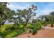 Picturesque backyard showcases lush greenery and a waterfront view with a bridge in the distance at 108 Fairbanks Oak Aly # 201, Charleston, SC 29492
