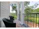 Inviting balcony featuring black wicker furniture and peaceful outdoor views at 108 Fairbanks Oak Aly # 201, Charleston, SC 29492