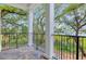 Enjoy beautiful natural views from this covered balcony with stone tile flooring at 108 Fairbanks Oak Aly # 201, Charleston, SC 29492