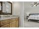 Bathroom with granite vanity and views into the Primary bedroom at 108 Fairbanks Oak Aly # 201, Charleston, SC 29492