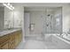 Bathroom with double vanity, glass shower, and luxurious soaking tub at 108 Fairbanks Oak Aly # 201, Charleston, SC 29492