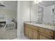 Bathroom vanity with granite counters, wood cabinetry, and marble floors at 108 Fairbanks Oak Aly # 201, Charleston, SC 29492